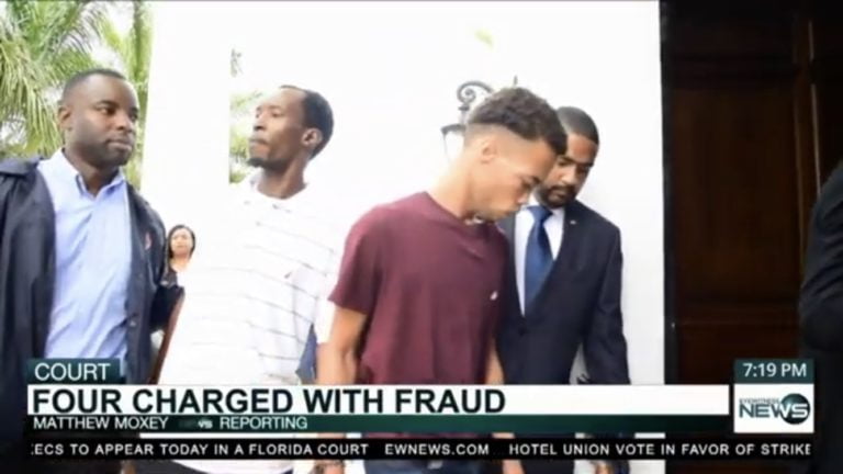 Four charged with fraud