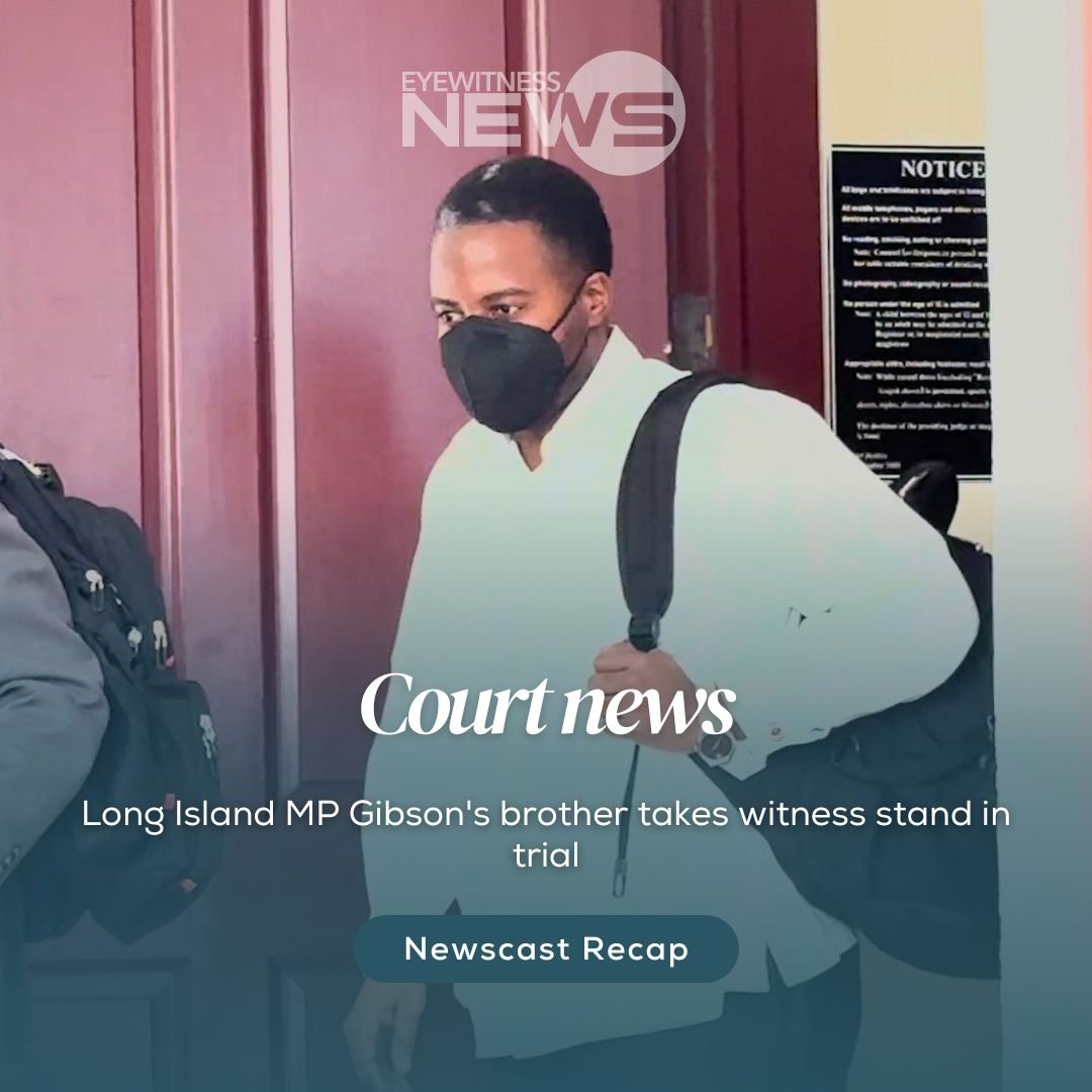 Straw market vendor admires her straw work